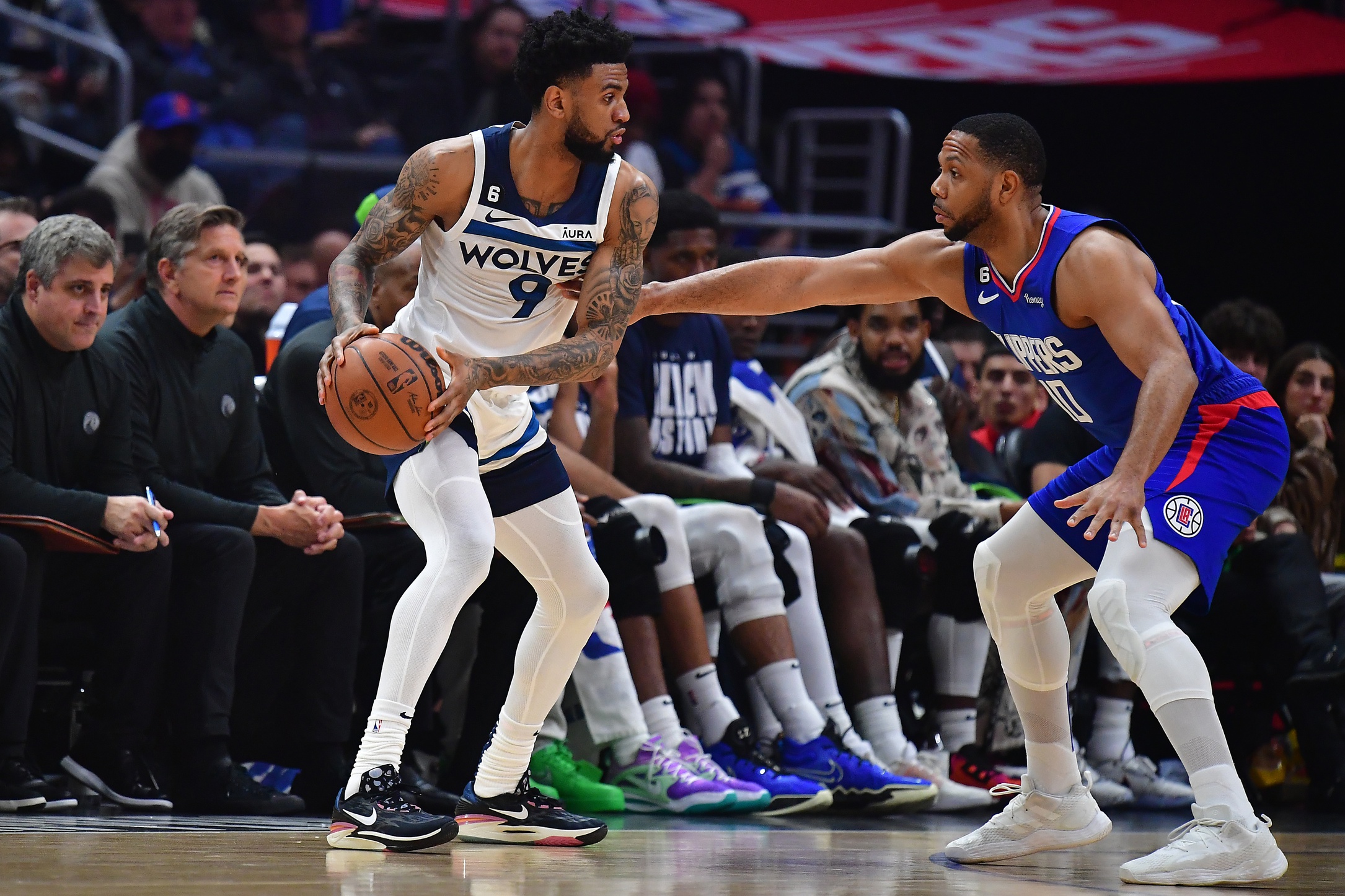 Feb 28, 2023; Los Angeles, California, USA; Minnesota Timberwolves guard Nickeil Alexander-Walker (9) controls the ball against Los Angeles Clippers guard Eric Gordon (10) during the first half at Crypto.com Arena. Mandatory Credit: Gary A. Vasquez-USA TODAY Sports