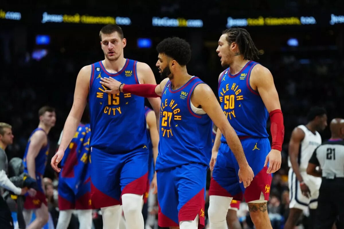 Mar 3, 2023; Denver, Colorado, USA; Denver Nuggets center Nikola Jokic (15) and guard Jamal Murray (27) and forward Aaron Gordon (50) celebrate after defeating the Memphis Grizzlies at Ball Arena. Mandatory Credit: Ron Chenoy-USA TODAY Sports