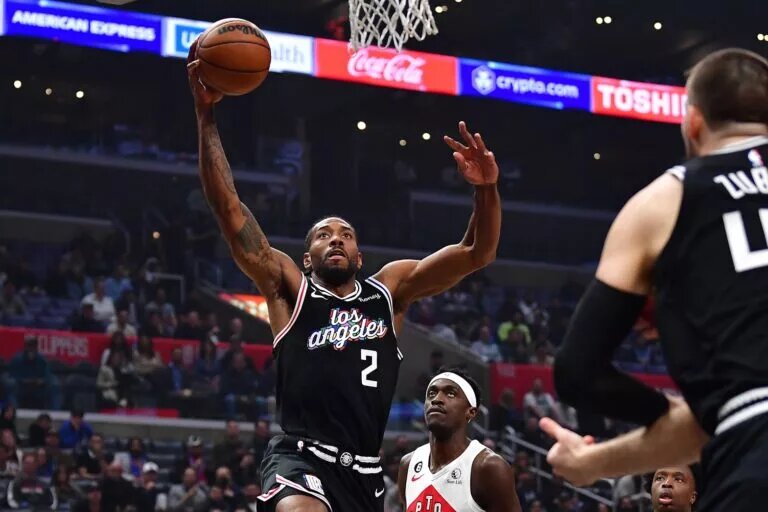 Mar 8, 2023; Los Angeles, California, USA; Los Angeles Clippers forward Kawhi Leonard (2) moves to the basket ahead of Toronto Raptors forward Pascal Siakam (43) during the first half at Crypto.com Arena. Mandatory Credit: Gary A. Vasquez-USA TODAY Sports