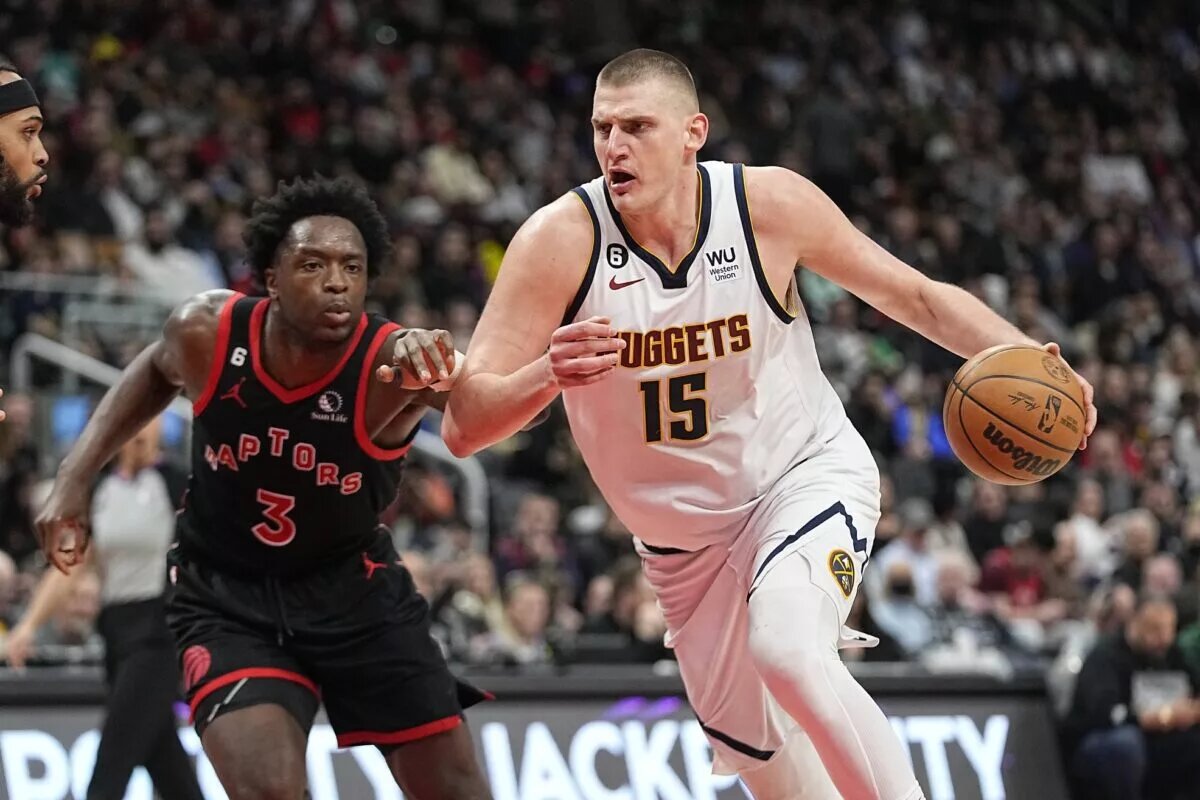 Mar 14, 2023; Toronto, Ontario, CAN; Denver Nuggets center Nikola Jokic (15) drives to the net against Toronto Raptors forward O.G. Anunoby (3) during the second half at Scotiabank Arena. Mandatory Credit: John E. Sokolowski-USA TODAY Sports