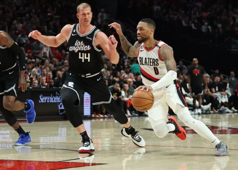 Mar 19, 2023; Portland, Oregon, USA; Portland Trail Blazers guard Damian Lillard (0) drives the lane past LA Clippers center Mason Plumlee (44) in the second half at Moda Center. Mandatory Credit: Jaime Valdez-USA TODAY Sports