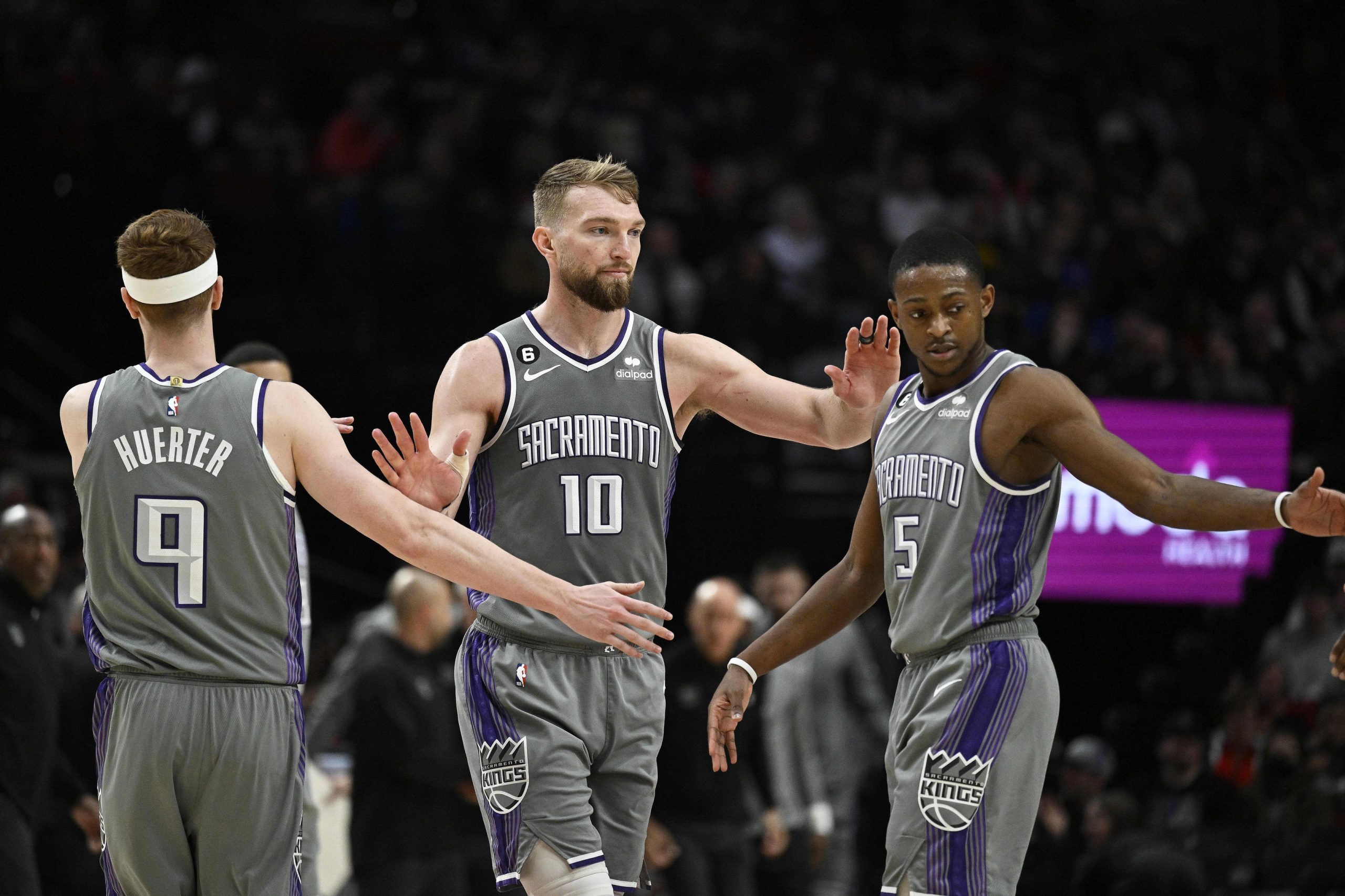 Mar 29, 2023; Portland, Oregon, USA; Sacramento Kings guard Kevin Huerter (9), forward Domantas Sabonis (10), and guard De'Aaron Fox (5) high-five each other during a time out in the second half against the Portland Trail Blazers at Moda Center. Mandatory Credit: Troy Wayrynen-USA TODAY Sports