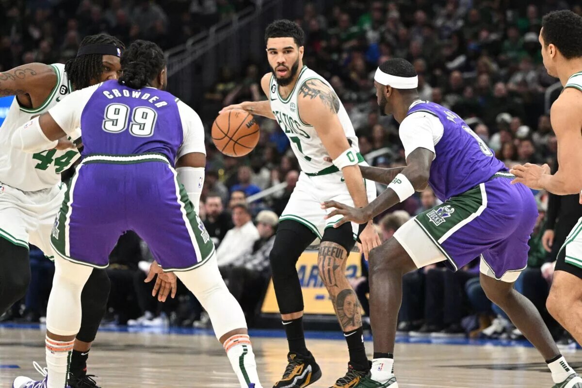Mar 30, 2023; Milwaukee, Wisconsin, USA; Boston Celtics forward Jayson Tatum (0) dribbles up the court against Milwaukee Bucks forward Bobby Portis (9) in the second half at Fiserv Forum. Mandatory Credit: Michael McLoone-USA TODAY Sports