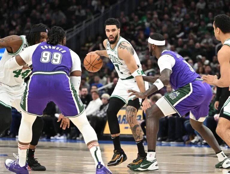 Mar 30, 2023; Milwaukee, Wisconsin, USA; Boston Celtics forward Jayson Tatum (0) dribbles up the court against Milwaukee Bucks forward Bobby Portis (9) in the second half at Fiserv Forum. Mandatory Credit: Michael McLoone-USA TODAY Sports