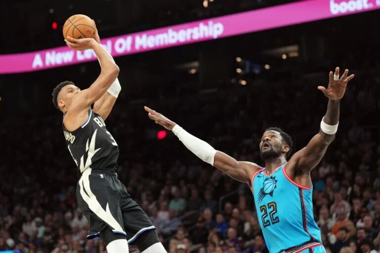 Mar 14, 2023; Phoenix, Arizona, USA; Milwaukee Bucks forward Giannis Antetokounmpo (34) shoots over Phoenix Suns center Deandre Ayton (22) during the second half at Footprint Center. Mandatory Credit: Joe Camporeale-USA TODAY Sports