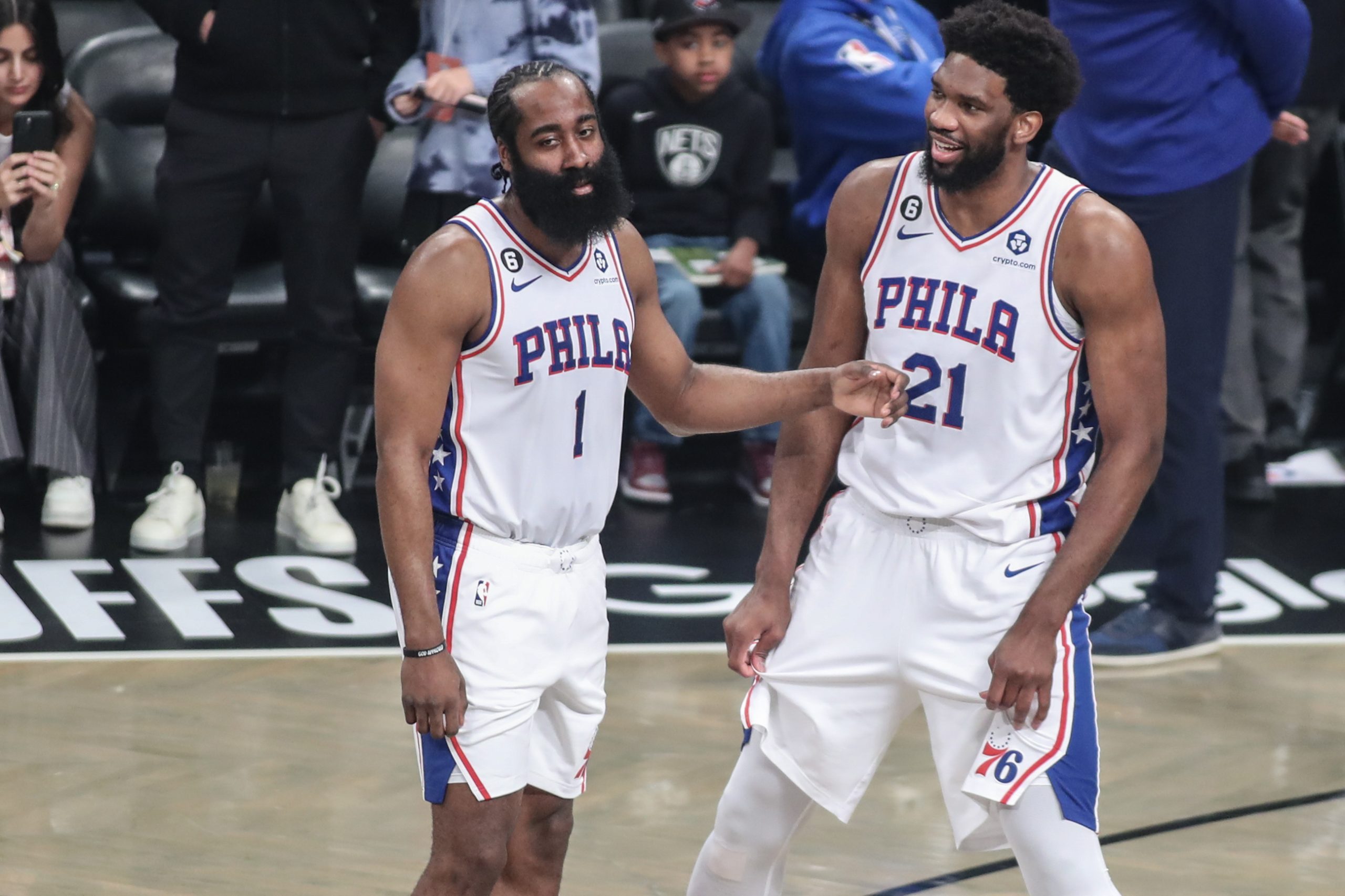 Apr 20, 2023; Brooklyn, New York, USA; Philadelphia 76ers guard James Harden (1) talks with center Joel Embiid (21) during an official’s review during game three of the 2023 NBA playoffs against the Brooklyn Nets at Barclays Center. Mandatory Credit: Wendell Cruz-USA TODAY Sports