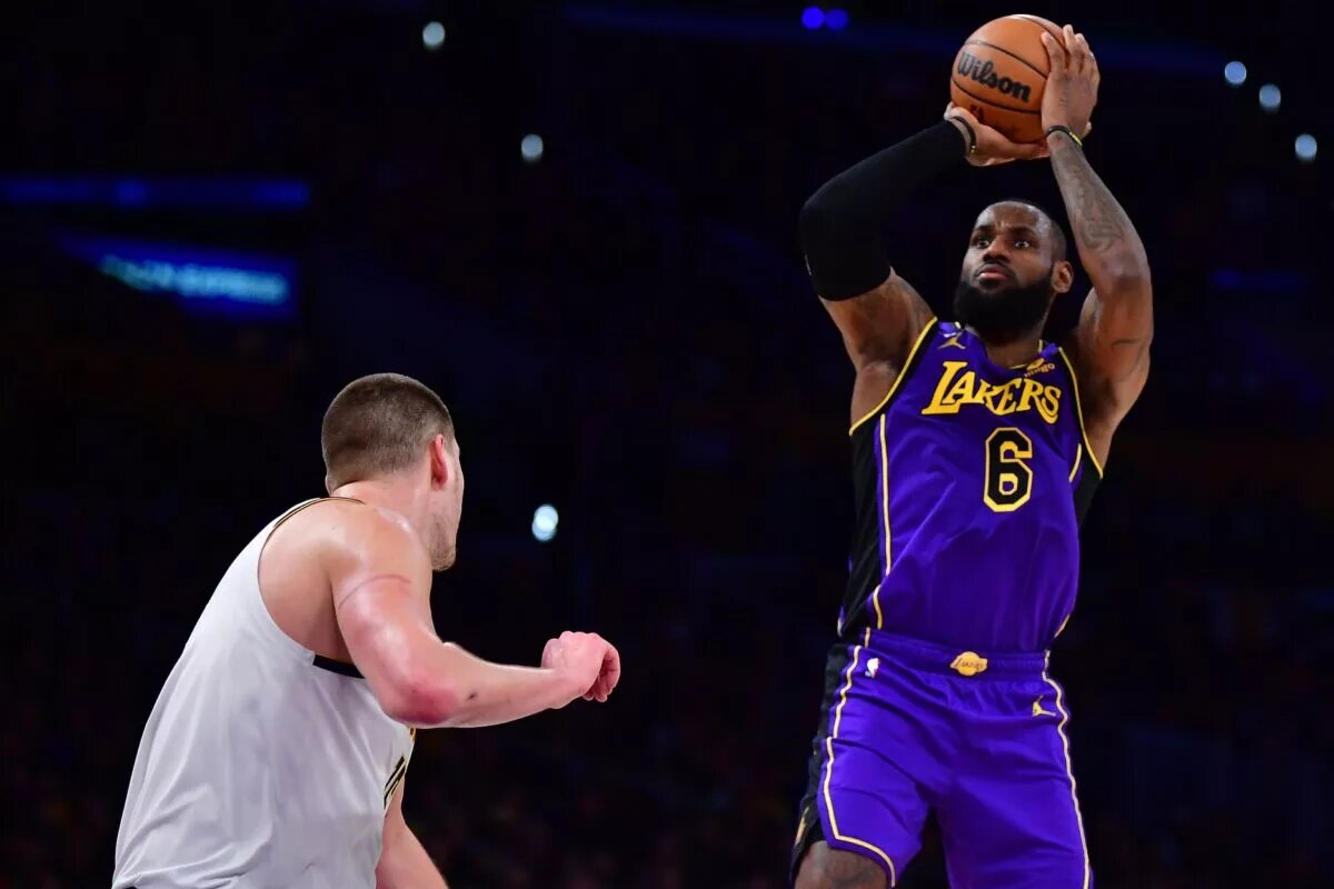 Dec 16, 2022; Los Angeles, California, USA; Los Angeles Lakers forward LeBron James (6) shoots against Denver Nuggets center Nikola Jokic (15) during the second half at Crypto.com Arena. Mandatory Credit: Gary A. Vasquez-USA TODAY Sports