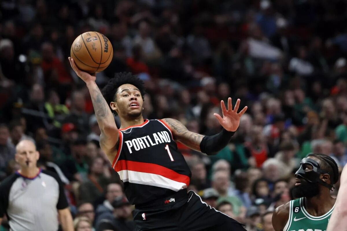 Mar 17, 2023; Portland, Oregon, USA; Portland Trail Blazers shooting guard Anfernee Simons (1) shoots the ball against Boston Celtics shooting guard Jaylen Brown (7) during the second half at Moda Center. Mandatory Credit: Soobum Im-USA TODAY Sports