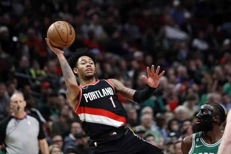 Mar 17, 2023; Portland, Oregon, USA; Portland Trail Blazers shooting guard Anfernee Simons (1) shoots the ball against Boston Celtics shooting guard Jaylen Brown (7) during the second half at Moda Center. Mandatory Credit: Soobum Im-USA TODAY Sports