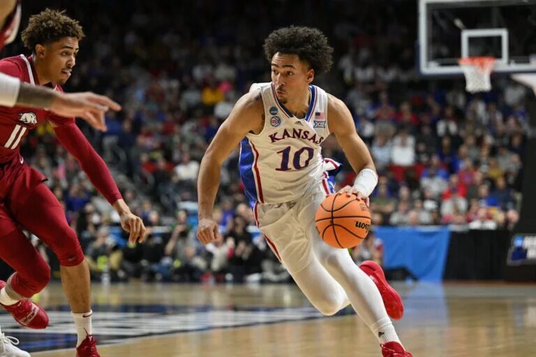 Mar 18, 2023; Des Moines, IA, USA; Kansas Jayhawks forward Jalen Wilson (10) drives against Arkansas Razorbacks forward Jalen Graham (11) during the first half at Wells Fargo Arena. Mandatory Credit: Jeffrey Becker-USA TODAY Sports
