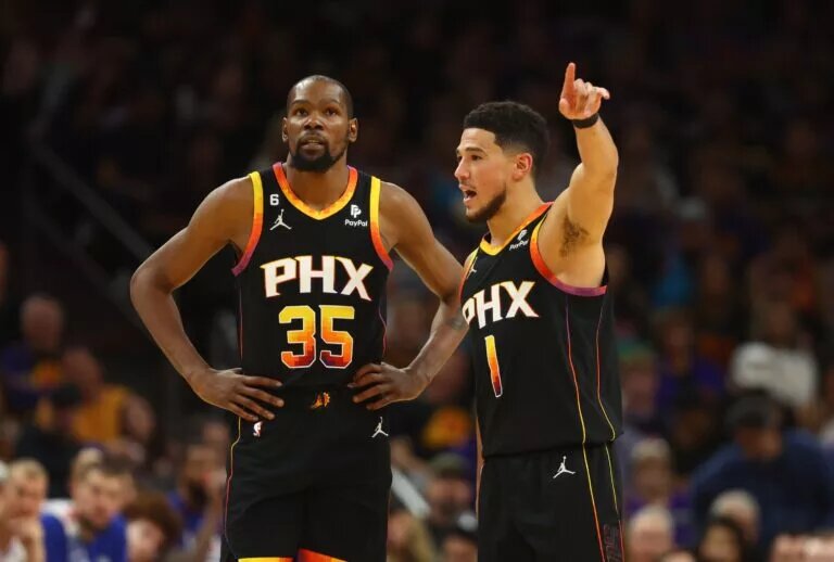 Apr 18, 2023; Phoenix, Arizona, USA; Phoenix Suns guard Devin Booker (1) with forward Kevin Durant (35) against the Los Angeles Clippers in the second half during game two of the 2023 NBA playoffs at Footprint Center. Mandatory Credit: Mark J. Rebilas-USA TODAY Sports