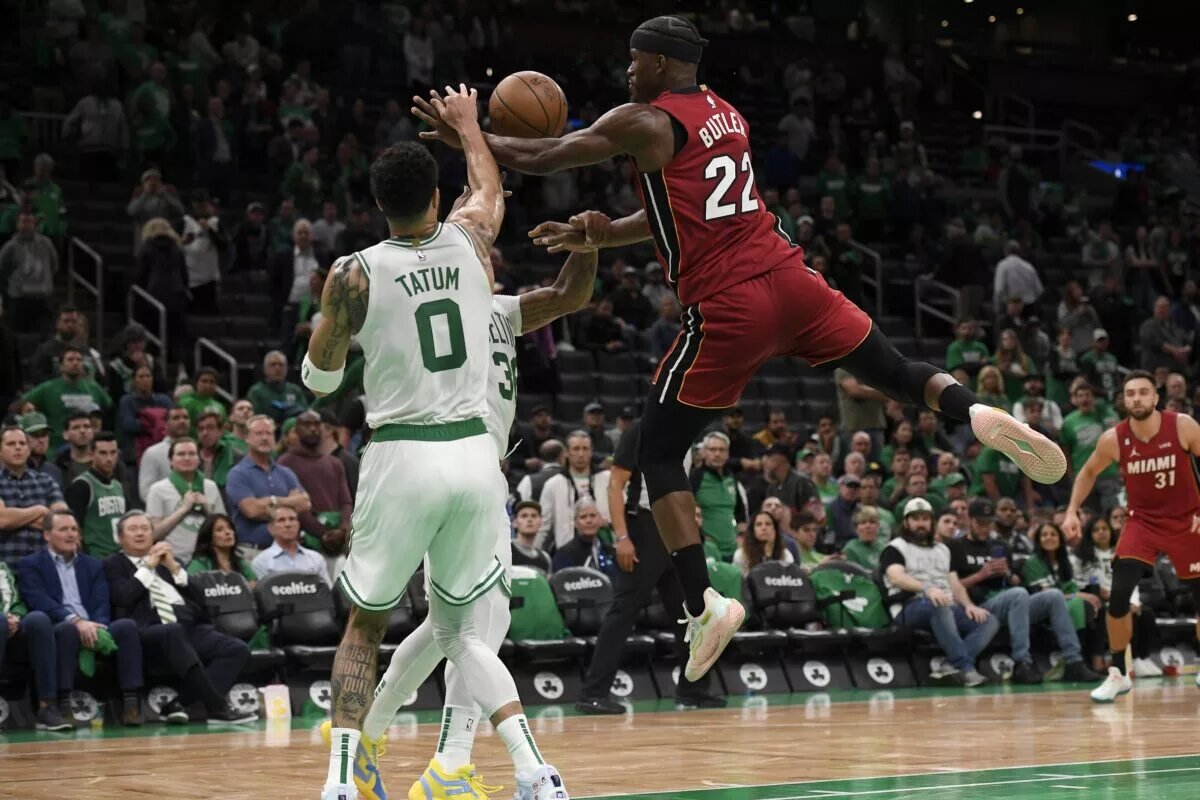 May 17, 2023; Boston, Massachusetts, USA; Miami Heat forward Jimmy Butler (22) and Boston Celtics forward Jayson Tatum (0) fight for a loose ball during the second half in game one of the Eastern Conference Finals for the 2023 NBA playoffs at TD Garden. Mandatory Credit: Bob DeChiara-USA TODAY Sports
