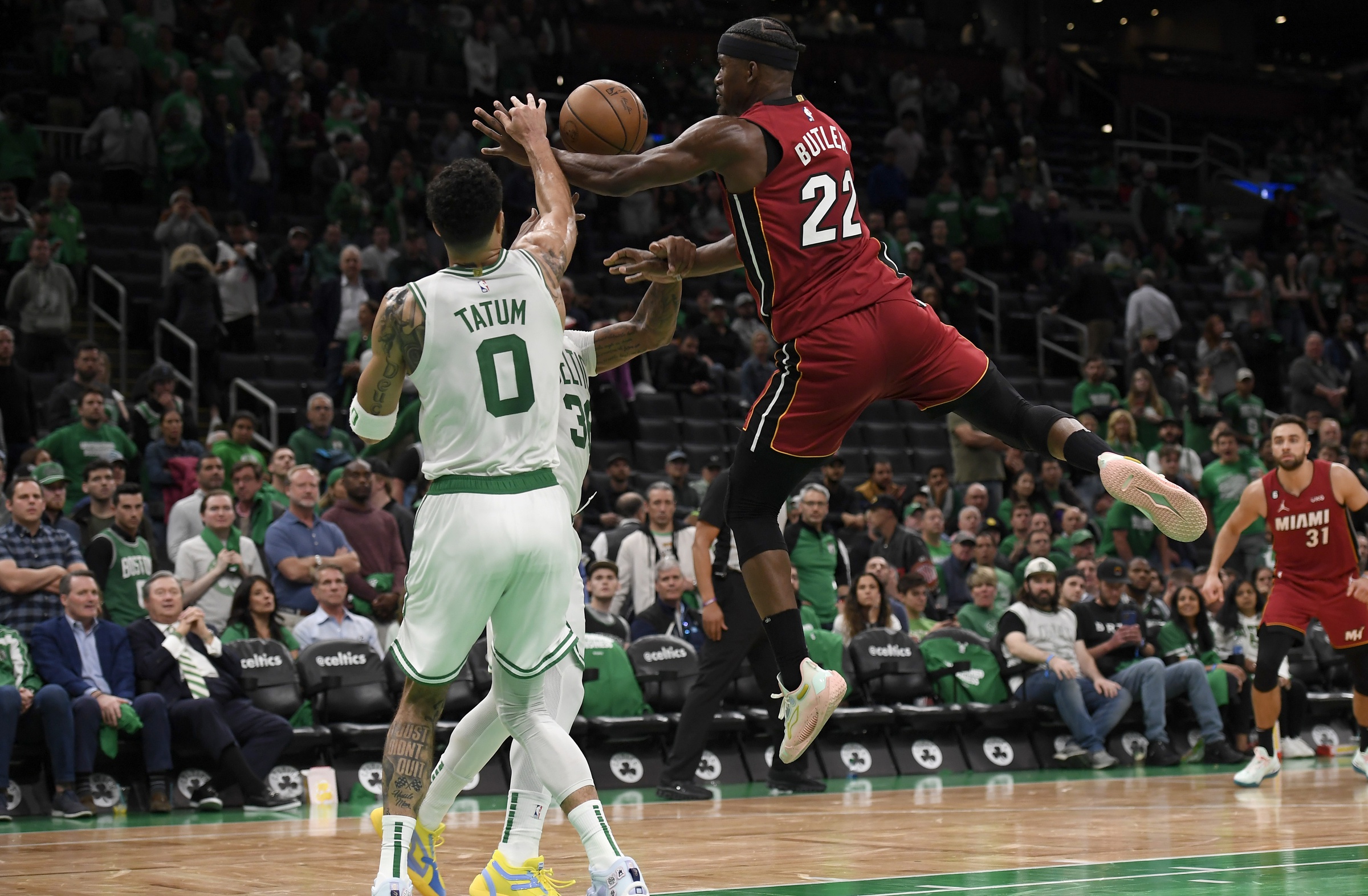 May 17, 2023; Boston, Massachusetts, USA; Miami Heat forward Jimmy Butler (22) and Boston Celtics forward Jayson Tatum (0) fight for a loose ball during the second half in game one of the Eastern Conference Finals for the 2023 NBA playoffs at TD Garden. Mandatory Credit: Bob DeChiara-USA TODAY Sports