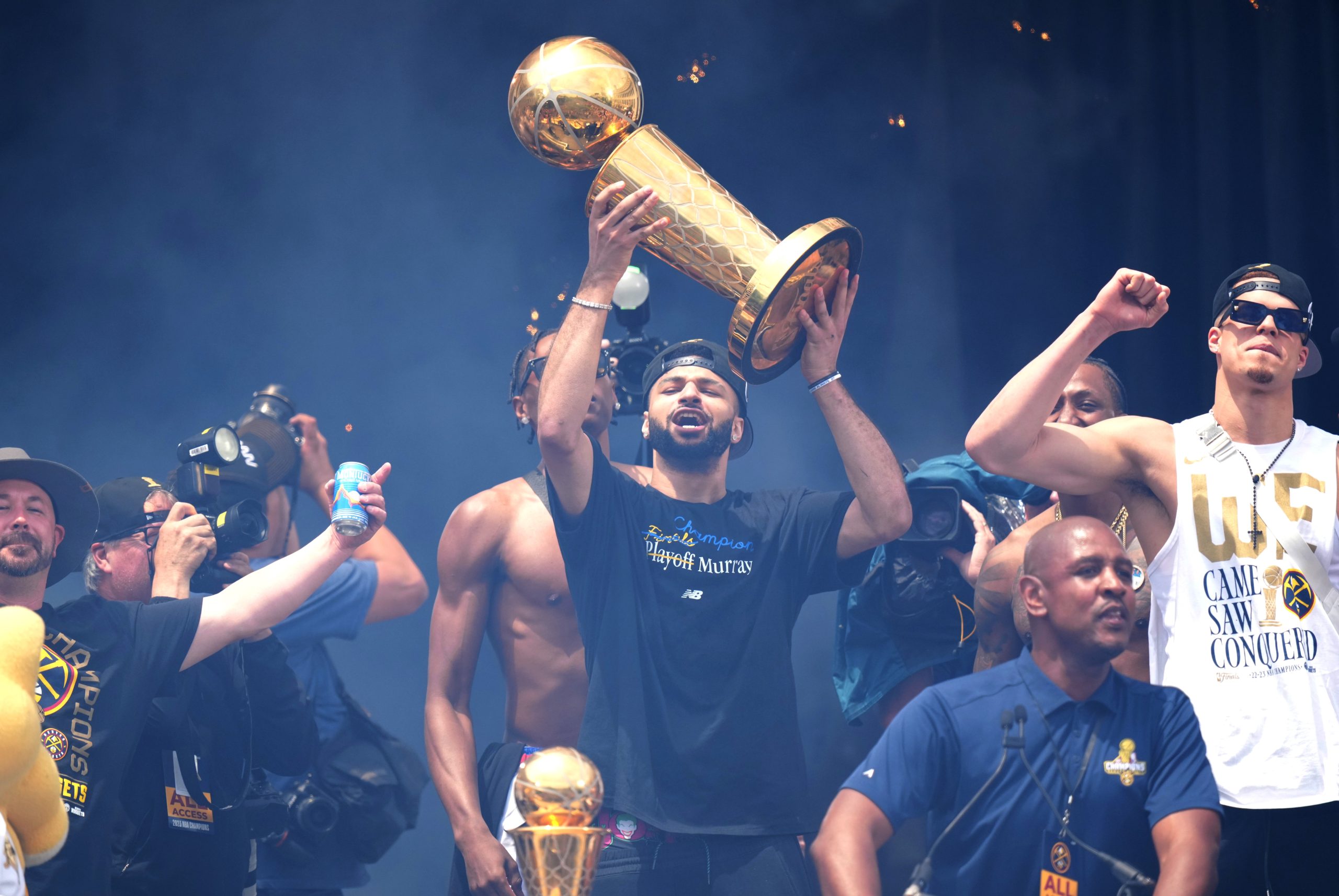 Denver Nuggets point guard Jamal Murray holding the Larry O'Brien trophy over his head at the Nuggets Championship parade