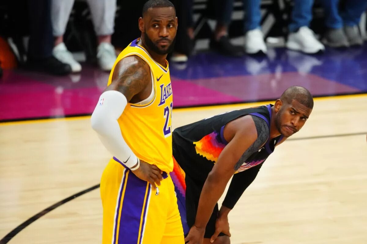 May 25, 2021; Phoenix, Arizona, USA; Los Angeles Lakers forward LeBron James (left) alongside Phoenix Suns guard Chris Paul during the second half in game two of the first round of the 2021 NBA Playoffs at Phoenix Suns Arena. Mandatory Credit: Mark J. Rebilas-USA TODAY Sports