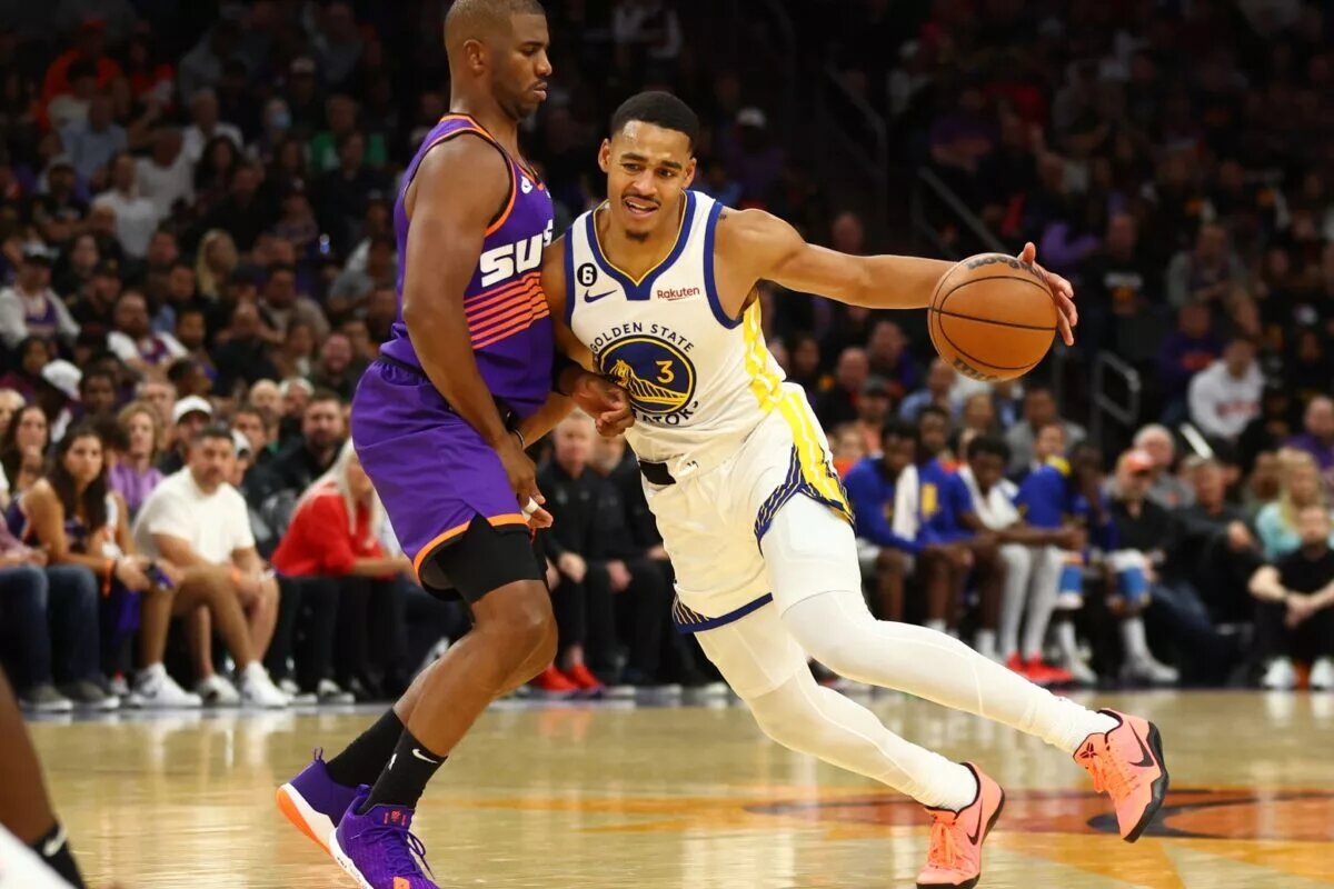 Oct 25, 2022; Phoenix, Arizona, USA; Golden State Warriors guard Jordan Poole (right) controls the ball against Phoenix Suns guard Chris Paul in the second half at Footprint Center. Mandatory Credit: Mark J. Rebilas-USA TODAY Sports