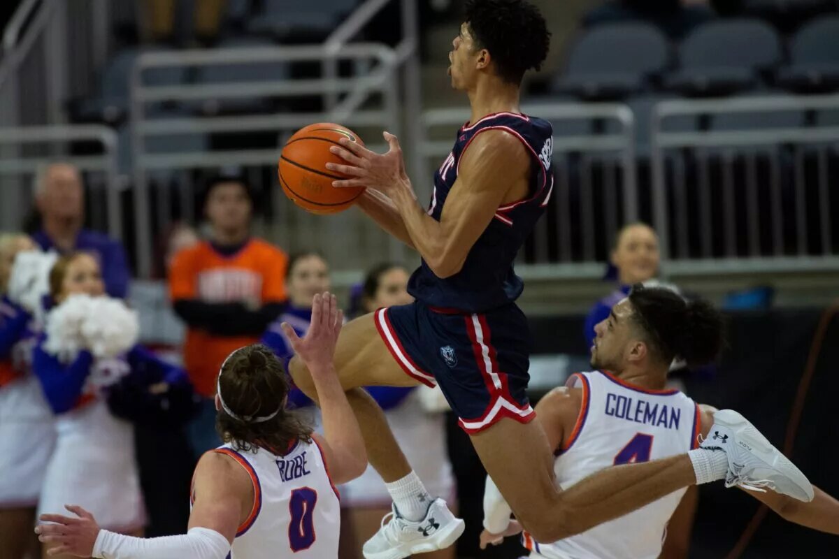 Belmont’s Ben Sheppard (22) jumps through Evansville’s Gabe Bobe (0) and Marvin Coleman II (4) as the University of Evansville Purple Aces play the Belmont University Bruins at Ford Center in Evansville, Ind., Wednesday, Jan. 25, 2023. Uevsbelmont 16