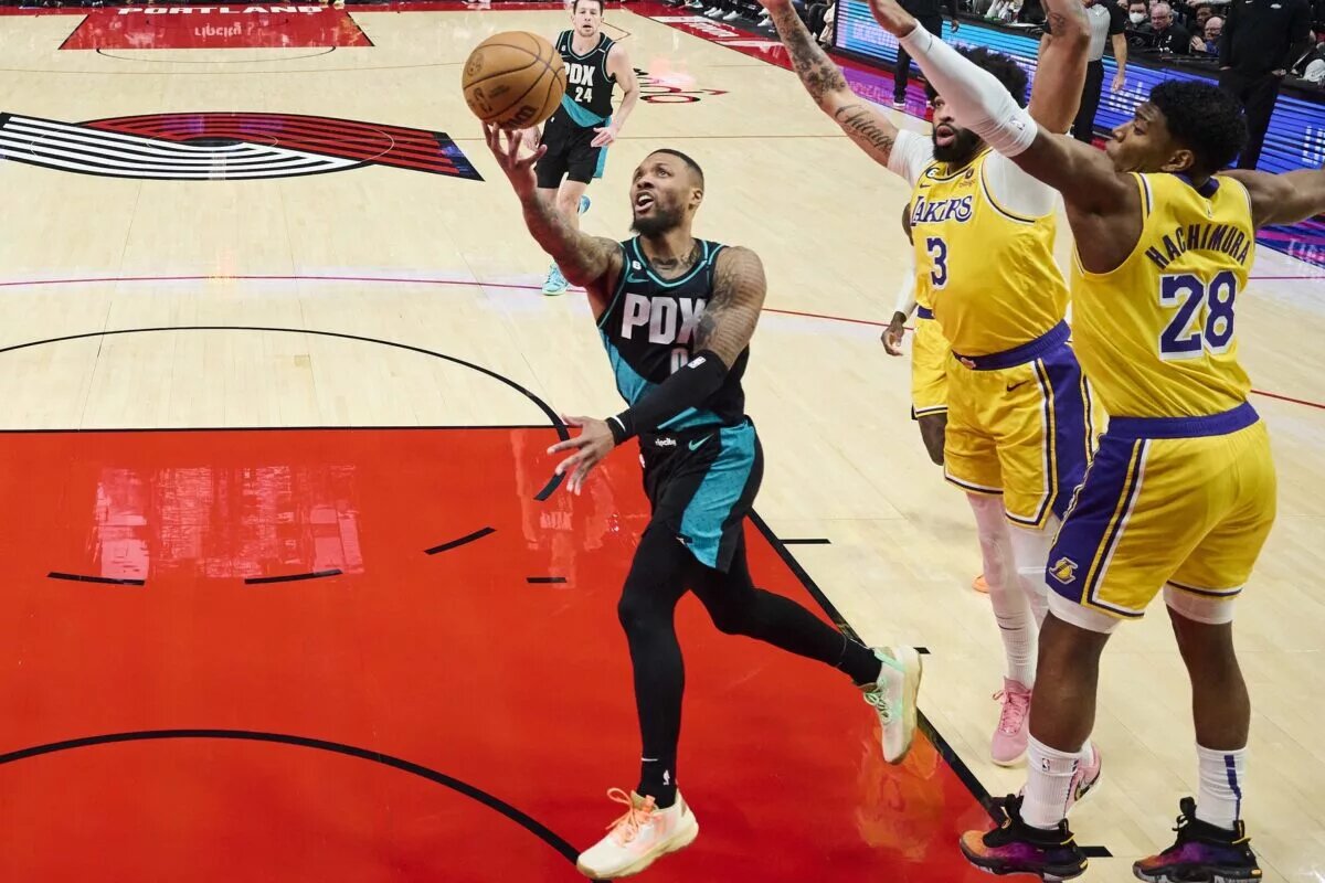 Feb 13, 2023; Portland, Oregon, USA; Portland Trail Blazers guard Damian Lillard (0) drives to the basket during the first half against Los Angeles Lakers forward Anthony Davis (3) and forward Rui Hachimura (28) at Moda Center. Mandatory Credit: Troy Wayrynen-USA TODAY Sports