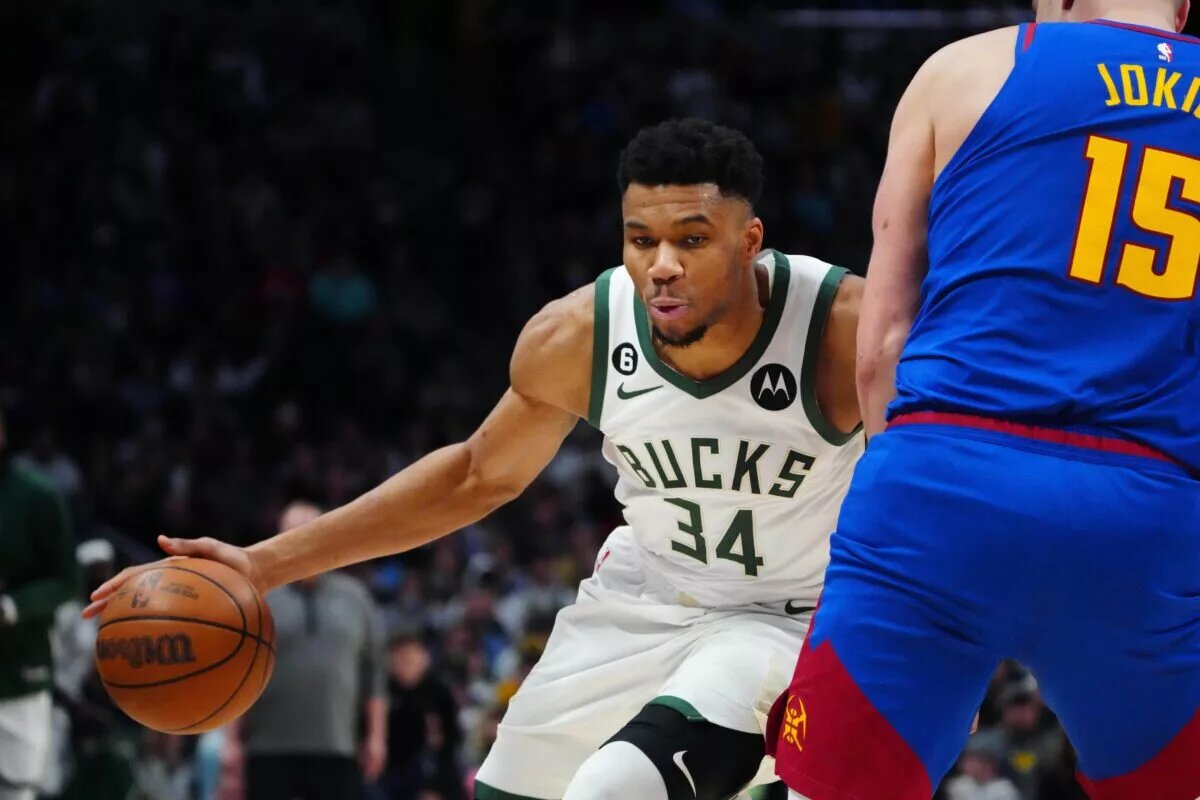 Mar 25, 2023; Denver, Colorado, USA; Milwaukee Bucks forward Giannis Antetokounmpo (34) drives at Denver Nuggets center Nikola Jokic (15) in the second quarter at Ball Arena. Mandatory Credit: Ron Chenoy-USA TODAY Sports