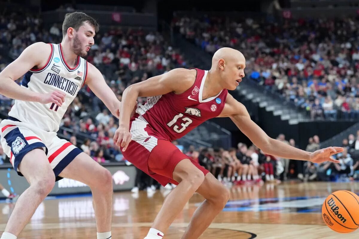 Mar 23, 2023; Las Vegas, NV, USA; Arkansas Razorbacks guard Jordan Walsh (13) reaches for the ball against UConn Huskies forward Alex Karaban (11) during the first half at T-Mobile Arena. Mandatory Credit: Joe Camporeale-USA TODAY Sports