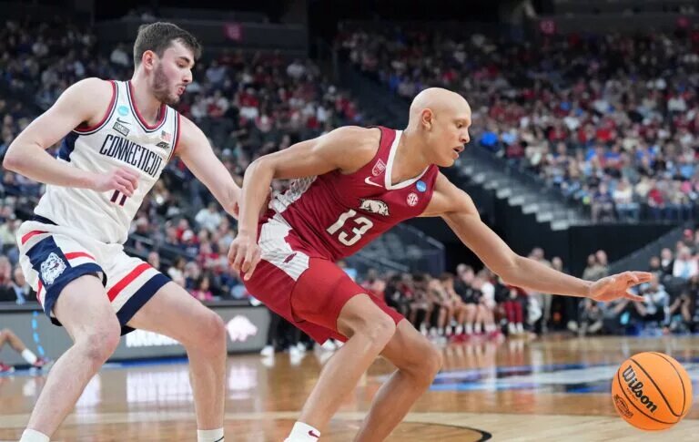 Mar 23, 2023; Las Vegas, NV, USA; Arkansas Razorbacks guard Jordan Walsh (13) reaches for the ball against UConn Huskies forward Alex Karaban (11) during the first half at T-Mobile Arena. Mandatory Credit: Joe Camporeale-USA TODAY Sports
