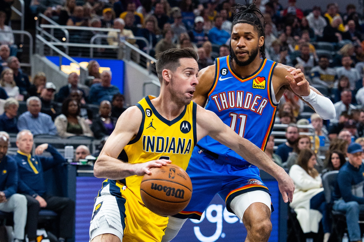 Mar 31, 2023; Indianapolis, Indiana, USA; Indiana Pacers guard T.J. McConnell (9) dribbles the ball while Oklahoma City Thunder guard Isaiah Joe (11) defends in the first quarter at Gainbridge Fieldhouse. Mandatory Credit: Trevor Ruszkowski-USA TODAY Sports