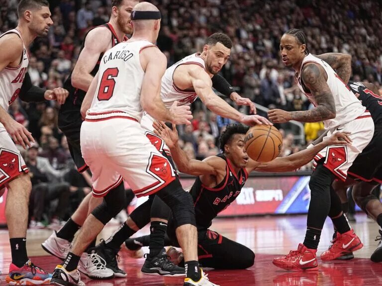 Apr 12, 2023; Toronto, Ontario, CAN; Chicago Bulls guard Zach LaVine (8) knocks the ball away from Toronto Raptors forward Scottie Barnes (4) as Chicago Bulls forward DeMar DeRozan (11) looks on during the second half of a NBA Play-In game at Scotiabank Arena. Mandatory Credit: John E. Sokolowski-USA TODAY Sports