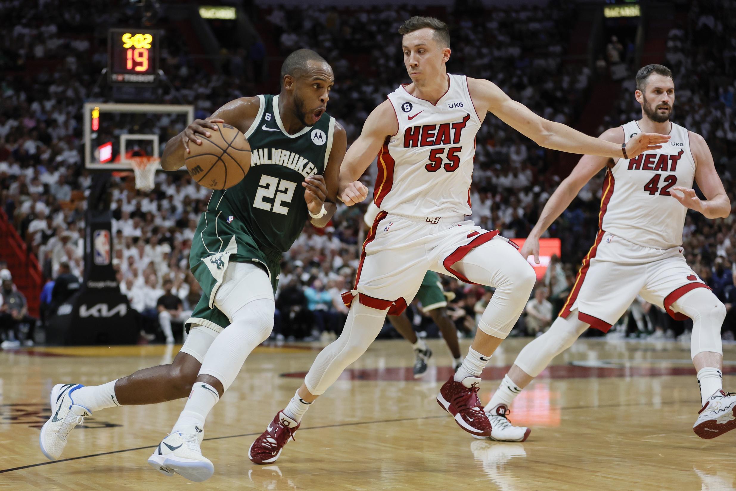 Apr 22, 2023; Miami, Florida, USA; Milwaukee Bucks forward Khris Middleton (22) drives to the basket against Miami Heat forward Duncan Robinson (55) in the second quarter during game three of the 2023 NBA Playoffs at Kaseya Center. Is Middleton's NBA contract one of the worst in the Eastern Conference? Mandatory Credit: Sam Navarro-USA TODAY Sports