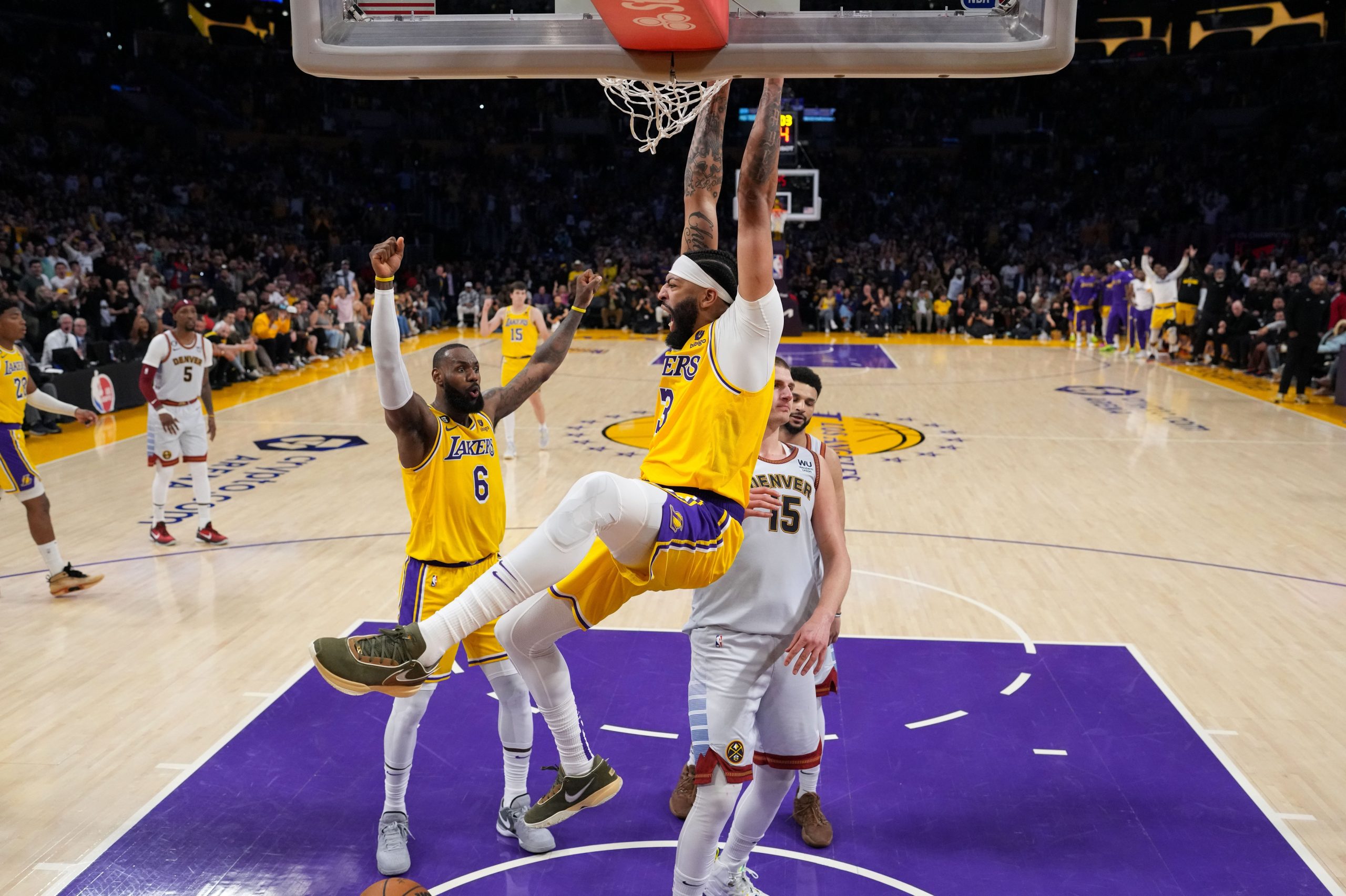 May 22, 2023; Los Angeles, California, USA; Los Angeles Lakers forward Anthony Davis (3) dunks the ball against Denver Nuggets center Nikola Jokic (15) during the fourth quarter in game four of the Western Conference Finals for the 2023 NBA playoffs at Crypto.com Arena. Mandatory Credit: Kirby Lee-USA TODAY Sports
