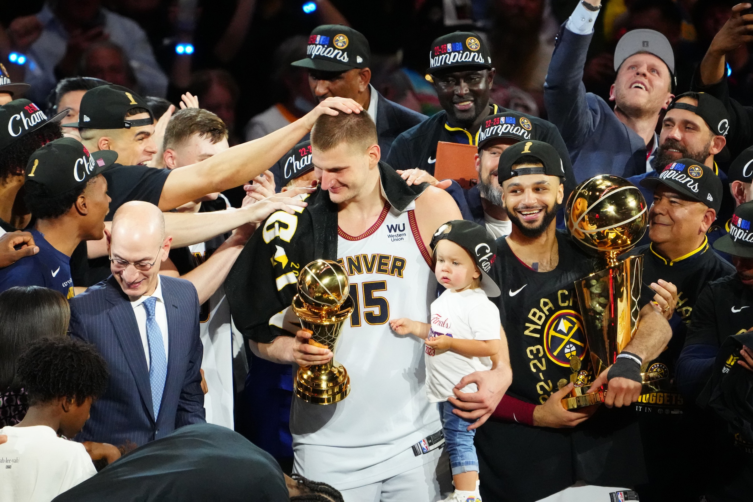 Jun 12, 2023; Denver, Colorado, USA; Denver Nuggets center Nikola Jokic (15) holds his daughter as he celebrates winning the Bill Russell NBA Finals MVP Award after the Nuggets won the 2023 NBA Championship against the Miami Heat at Ball Arena. Mandatory Credit: Ron Chenoy-USA TODAY Sports