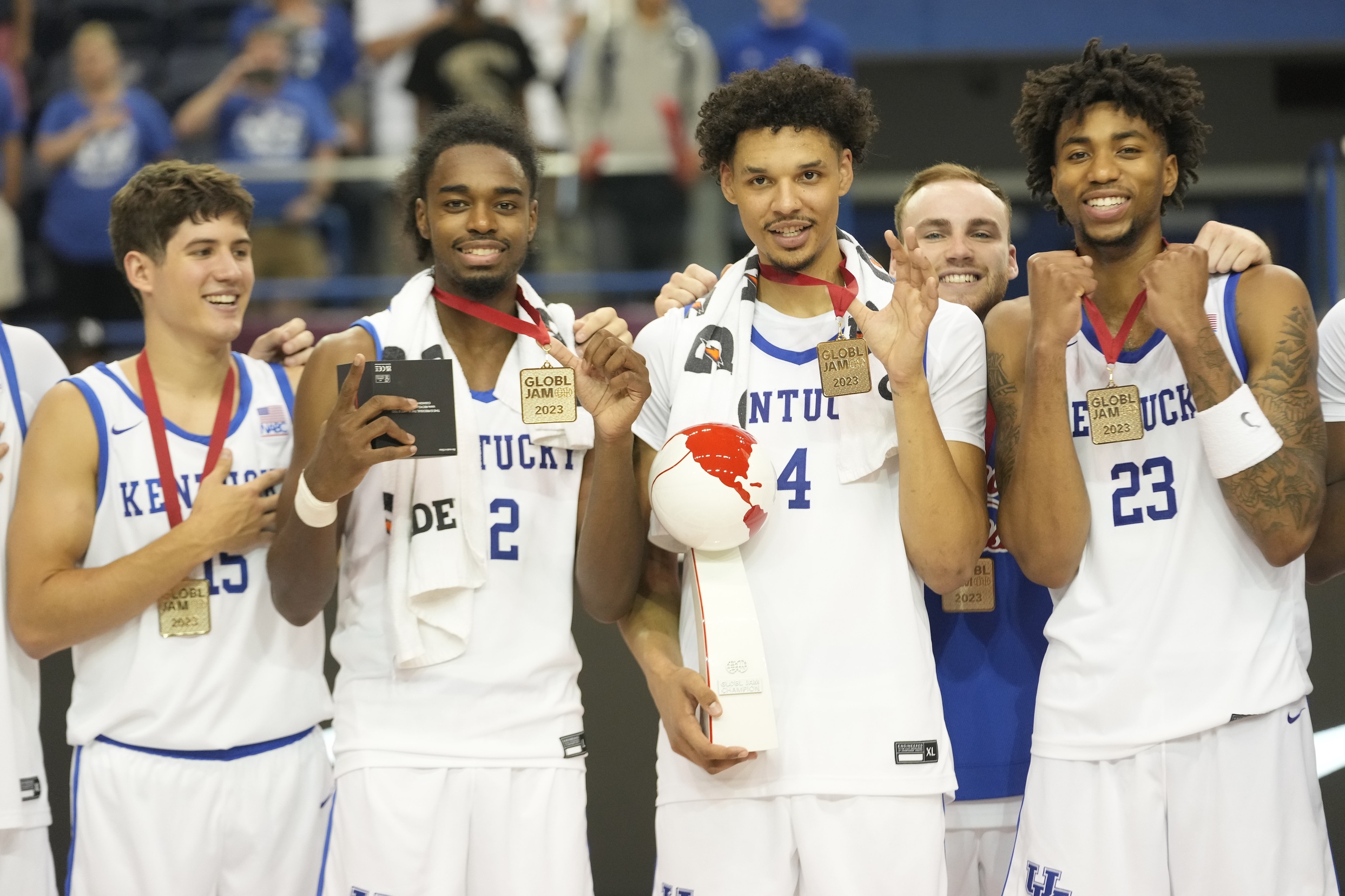 Jul 16, 2023; Toronto, Ontario, Canada; USA-Kentucky guard Reed Sheppard (15) and guard Antonio Reeves (12) and forward Tre Mitchell (4) and guard Jordan Burks (23) pose with their tournament medals and trophy after defeating Canada in the Men's Gold game at Mattamy Athletic Centre. Mandatory Credit: John E. Sokolowski-USA TODAY Sports
