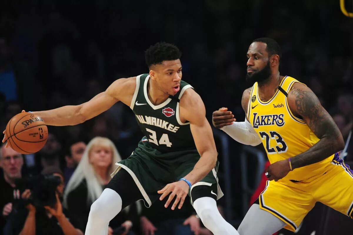 March 6, 2020; Los Angeles, California, USA; Milwaukee Bucks forward Giannis Antetokounmpo (34) controls the ball against Los Angeles Lakers forward LeBron James (23) during the first half at Staples Center. Mandatory Credit: Gary A. Vasquez-USA TODAY Sports