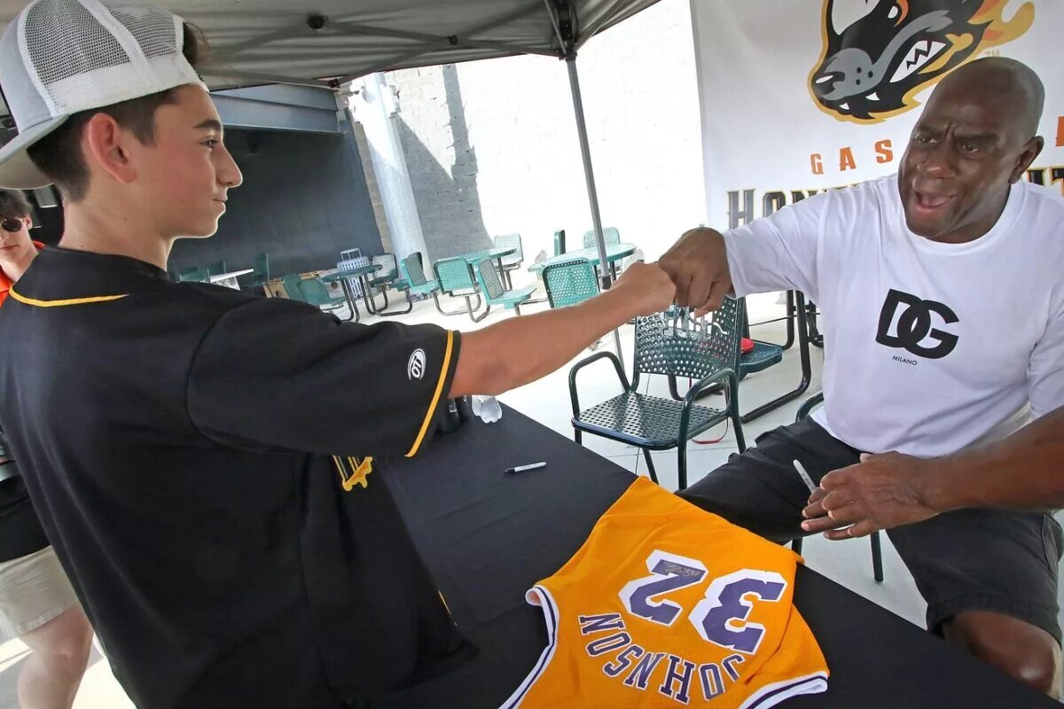 Sixteen-year-old Bryson Peoples has a jersey signed by Magic Johnson Friday afternoon, September 9, 2022, prior to the Honey Hunter’s game at CaroMont Health Park. Magic1b