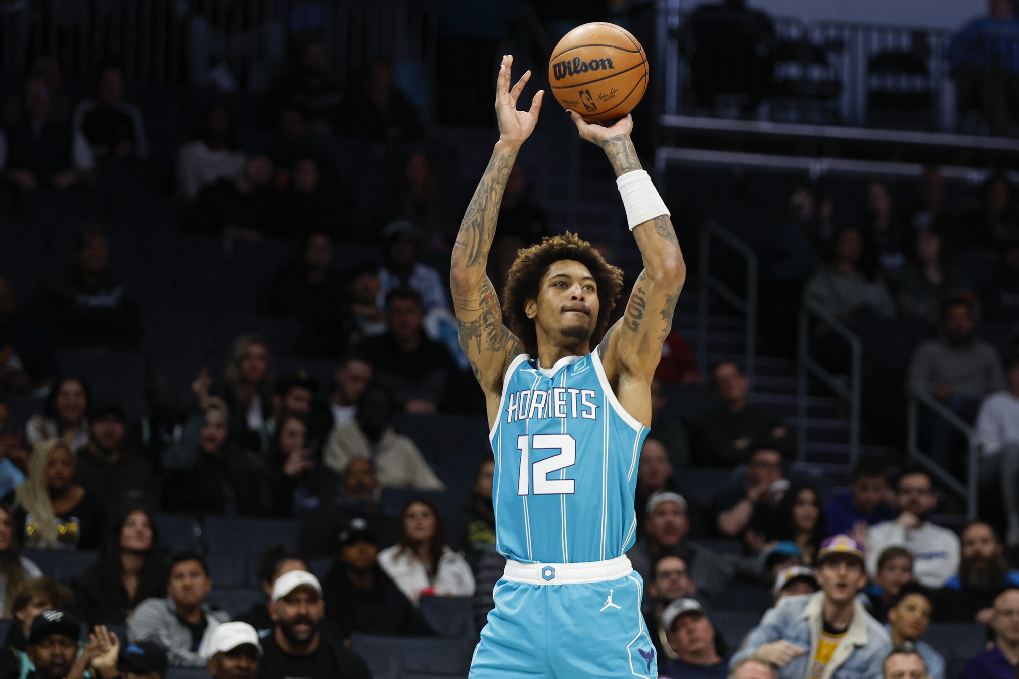Mar 20, 2023; Charlotte, North Carolina, USA; Charlotte Hornets guard Kelly Oubre Jr. (12) shoots a 3-pointer against the Indiana Pacers during the second half at Spectrum Center. The Charlotte Hornets won 115-109. Mandatory Credit: Nell Redmond-USA TODAY Sports