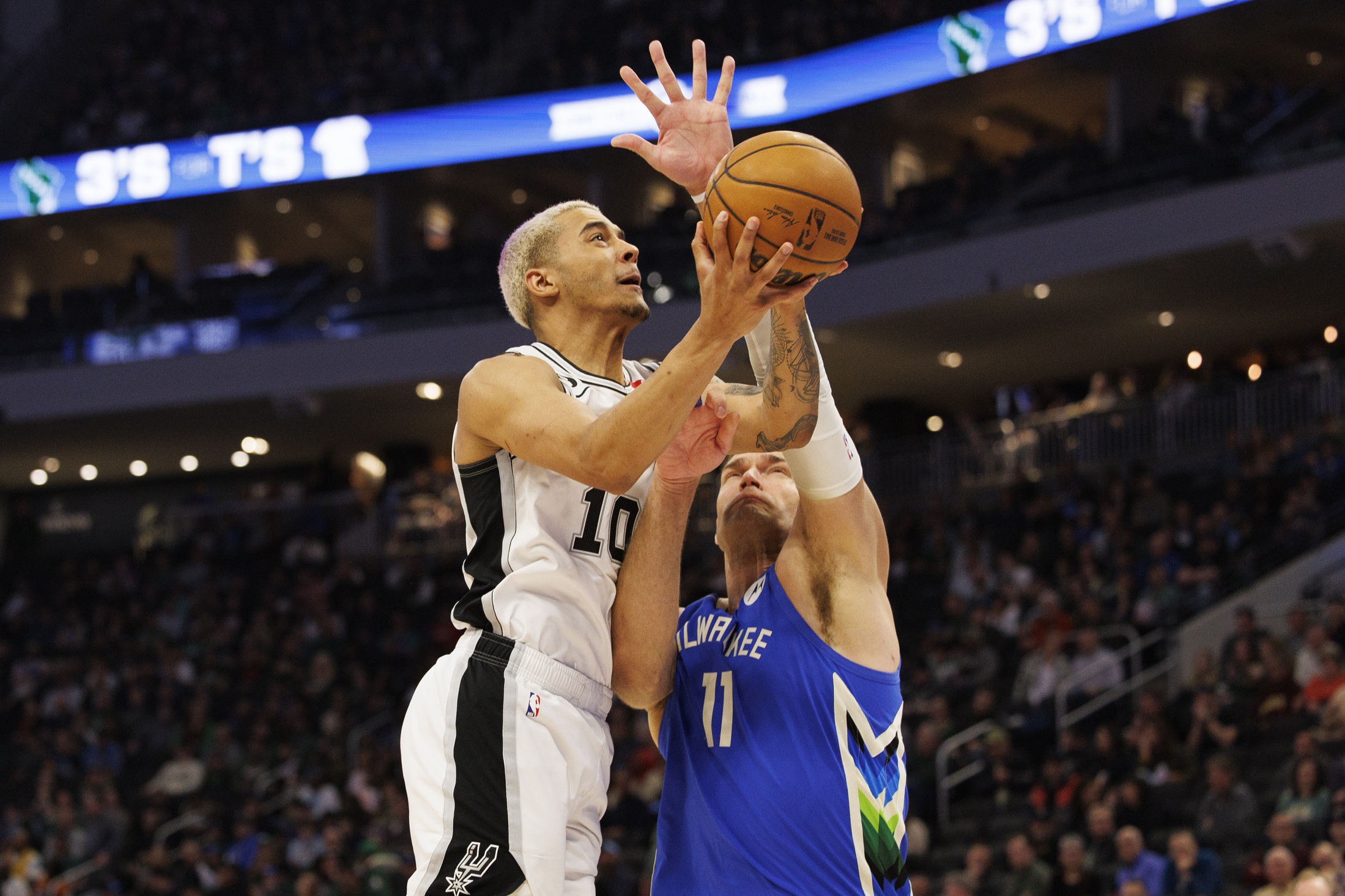 Mar 22, 2023; Milwaukee, Wisconsin, USA; San Antonio Spurs forward Jeremy Sochan (10) shoots against Milwaukee Bucks center Brook Lopez (11) during the third quarter at Fiserv Forum. Mandatory Credit: Jeff Hanisch-USA TODAY Sports