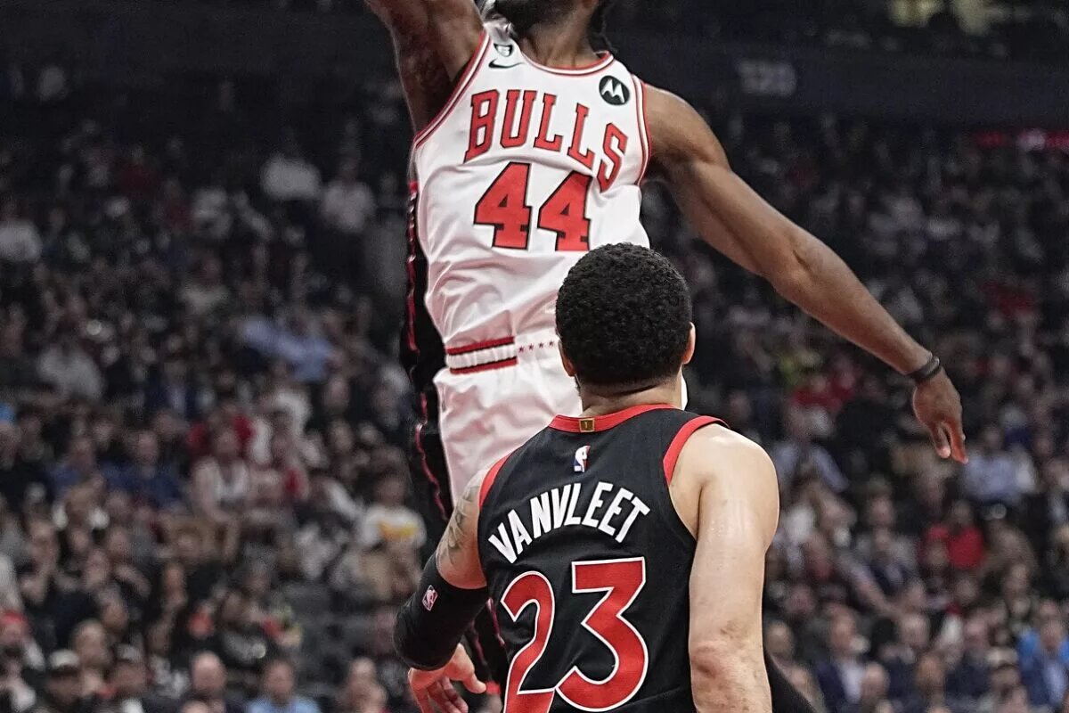 Apr 12, 2023; Toronto, Ontario, CAN; Chicago Bulls forward Patrick Williams (44) dunks as Toronto Raptors guard Fred VanVleet (23) looks on during the first half of the NBA Play-In game at Scotiabank Arena. Mandatory Credit: John E. Sokolowski-USA TODAY Sports. Williams will battle out Torey Craig in the Chicago Bulls rotation.