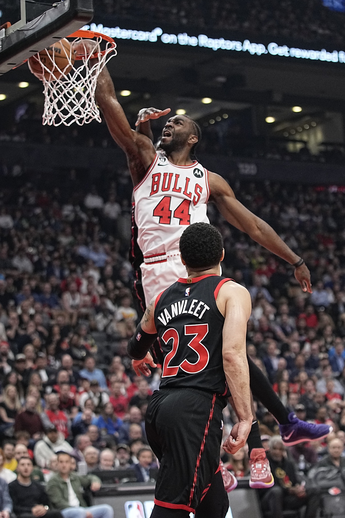 Apr 12, 2023; Toronto, Ontario, CAN; Chicago Bulls forward Patrick Williams (44) dunks as Toronto Raptors guard Fred VanVleet (23) looks on during the first half of the NBA Play-In game at Scotiabank Arena. Mandatory Credit: John E. Sokolowski-USA TODAY Sports. Williams will battle out Torey Craig in the Chicago Bulls rotation.