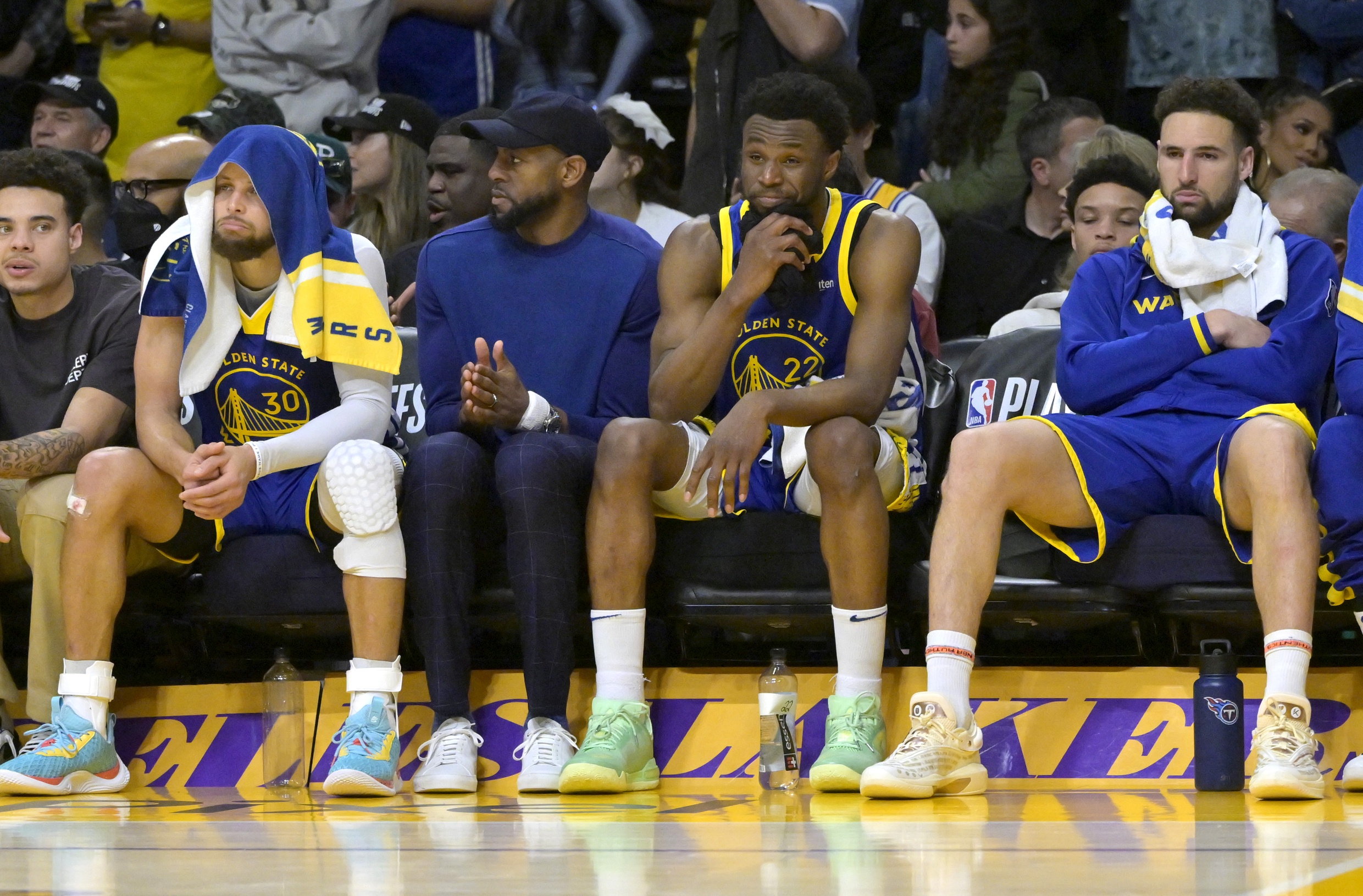 May 12, 2023; Los Angeles, California, USA; Golden State Warriors guard Stephen Curry (30) Andre Iguodala (9), guard Ryan Rollins (2) and guard Klay Thompson (11) sit on from the bench in the final minutes of the second half of game six of the 2023 NBA playoffs against the Los Angeles Lakers at Crypto.com Arena. Mandatory Credit: Jayne Kamin-Oncea-USA TODAY Sports