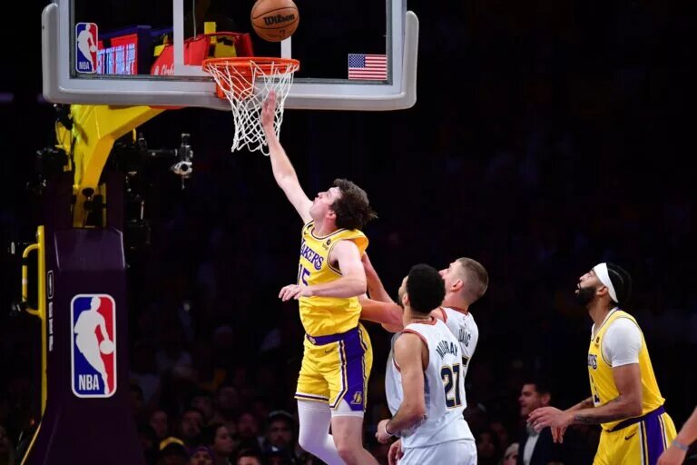 May 22, 2023; Los Angeles, California, USA; Los Angeles Lakers and FIBA Star Guard Austin Reaves (15) shoots the ball against Denver Nuggets center Nikola Jokic (15) during the second quarter in game four of the Western Conference Finals for the 2023 NBA playoffs at Crypto.com Arena. Mandatory Credit: Gary A. Vasquez-USA TODAY Sports
