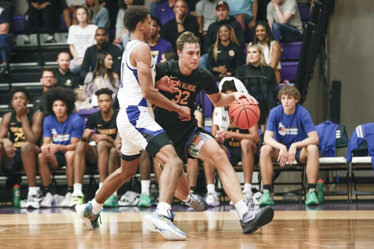 Dec 1, 2022; Montverde, Florida, USA; Montverde Academy forward Cooper Flagg (32) (UConn's targeted recruit) drives past IMG Academy forward Khani Rooths (left) during the second half of the Sunshine Classic basketball tournament at Mills Championship Court on the campus of Montverde Academy. Mandatory Credit: Reinhold Matay-USA TODAY Sports