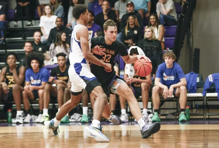 Dec 1, 2022; Montverde, Florida, USA; Montverde Academy forward Cooper Flagg (32) (UConn's targeted recruit) drives past IMG Academy forward Khani Rooths (left) during the second half of the Sunshine Classic basketball tournament at Mills Championship Court on the campus of Montverde Academy. Mandatory Credit: Reinhold Matay-USA TODAY Sports