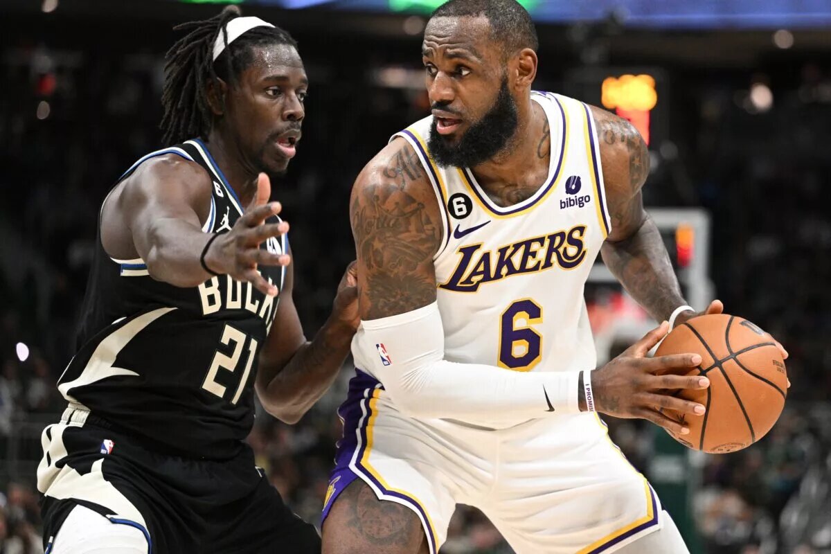Dec 2, 2022; Milwaukee, Wisconsin, USA; Los Angeles Lakers forward LeBron James (6) posts up against Milwaukee Bucks guard Jrue Holiday (21) in the second quarter at Fiserv Forum. Mandatory Credit: Michael McLoone-USA TODAY Sports
