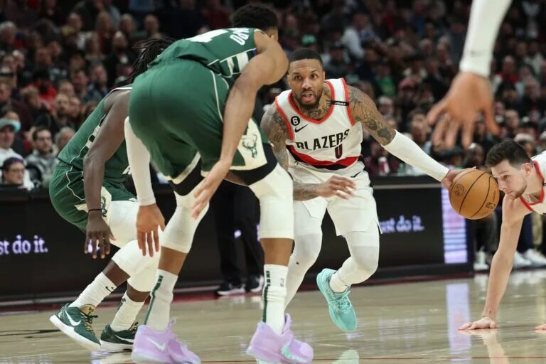 Feb 6, 2023; Portland, Oregon, USA; Portland Trail Blazers guard Damian Lillard (0) dribbles the ball against Milwaukee Bucks forward Giannis Antetokounmpo (34) in the second half at Moda Center. Mandatory Credit: Jaime Valdez-USA TODAY Sports