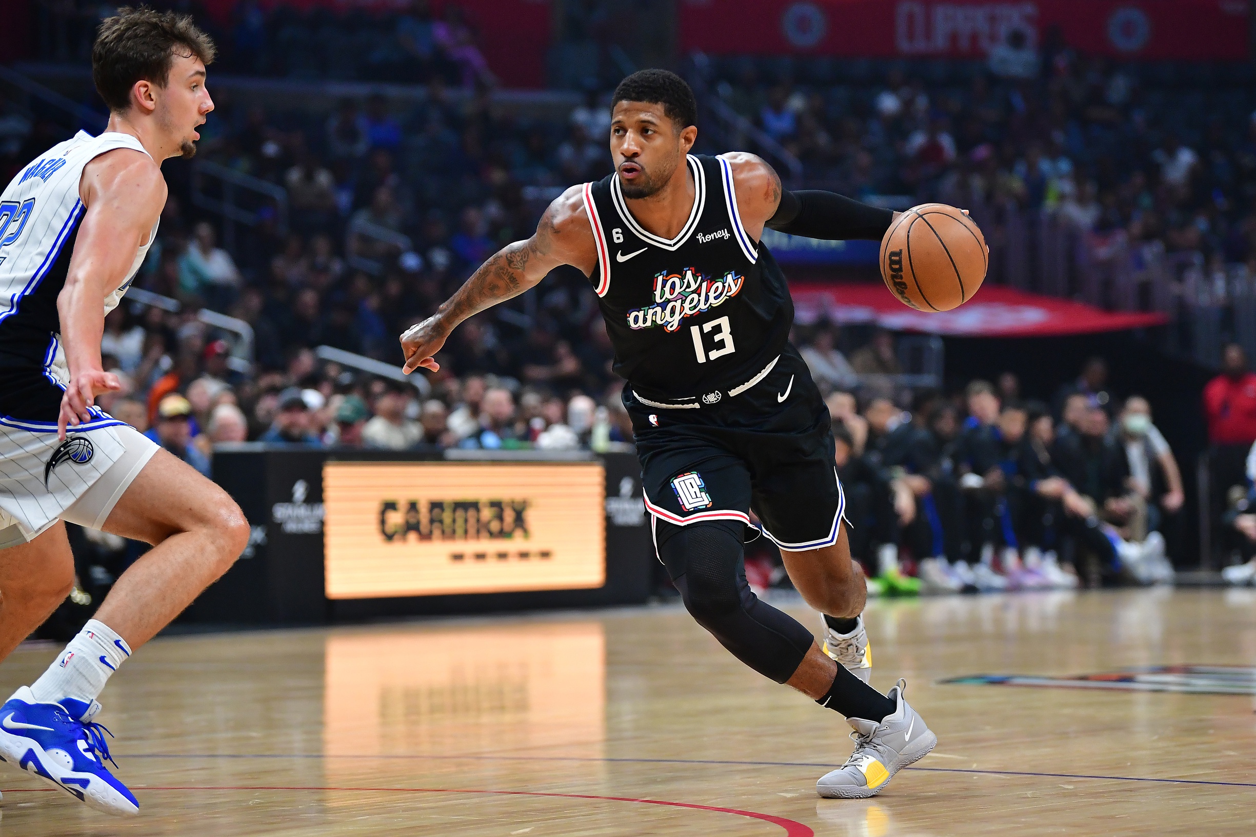 Mar 18, 2023; Los Angeles, California, USA; Los Angeles Clippers forward Paul George (13) moves to the basket against Orlando Magic forward Franz Wagner (22) during the first half at Crypto.com Arena. Mandatory Credit: Gary A. Vasquez-USA TODAY Sports