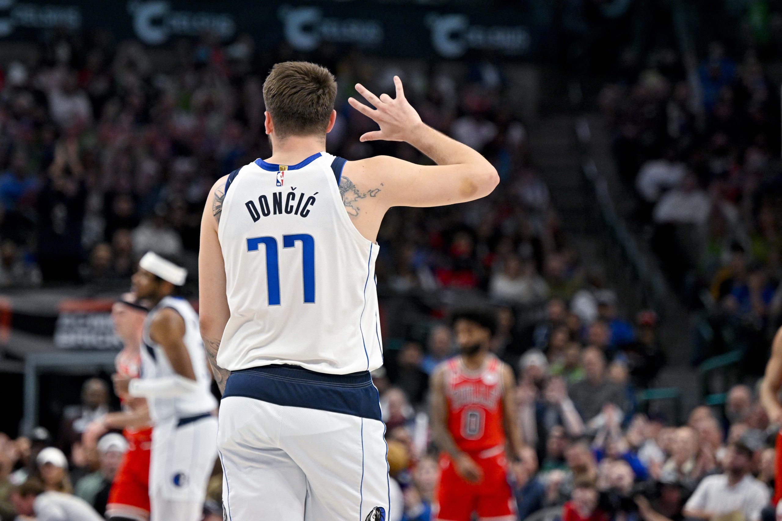 Apr 7, 2023; Dallas, Texas, USA; Dallas Mavericks guard Luka Doncic (77) celebrates after forward Davis Bertans (44) makes a three point shot against the Chicago Bulls during the first quarter at the American Airlines Center. Mandatory Credit: Jerome Miron-USA TODAY Sports