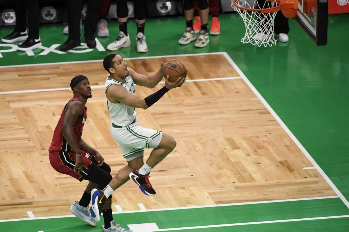 May 19, 2023; Boston, Massachusetts, USA; Boston Celtics guard Malcolm Brogdon (13) shoots past Miami Heat forward Jimmy Butler (22) during the second half of game two of the Eastern Conference Finals for the 2023 NBA playoffs at TD Garden. Mandatory Credit: Bob DeChiara-USA TODAY Sports. He is recent Boston Celtic trade news from this past week.
