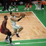 May 19, 2023; Boston, Massachusetts, USA; Boston Celtics guard Malcolm Brogdon (13) shoots past Miami Heat forward Jimmy Butler (22) during the second half of game two of the Eastern Conference Finals for the 2023 NBA playoffs at TD Garden. Mandatory Credit: Bob DeChiara-USA TODAY Sports. He is recent Boston Celtic trade news from this past week.