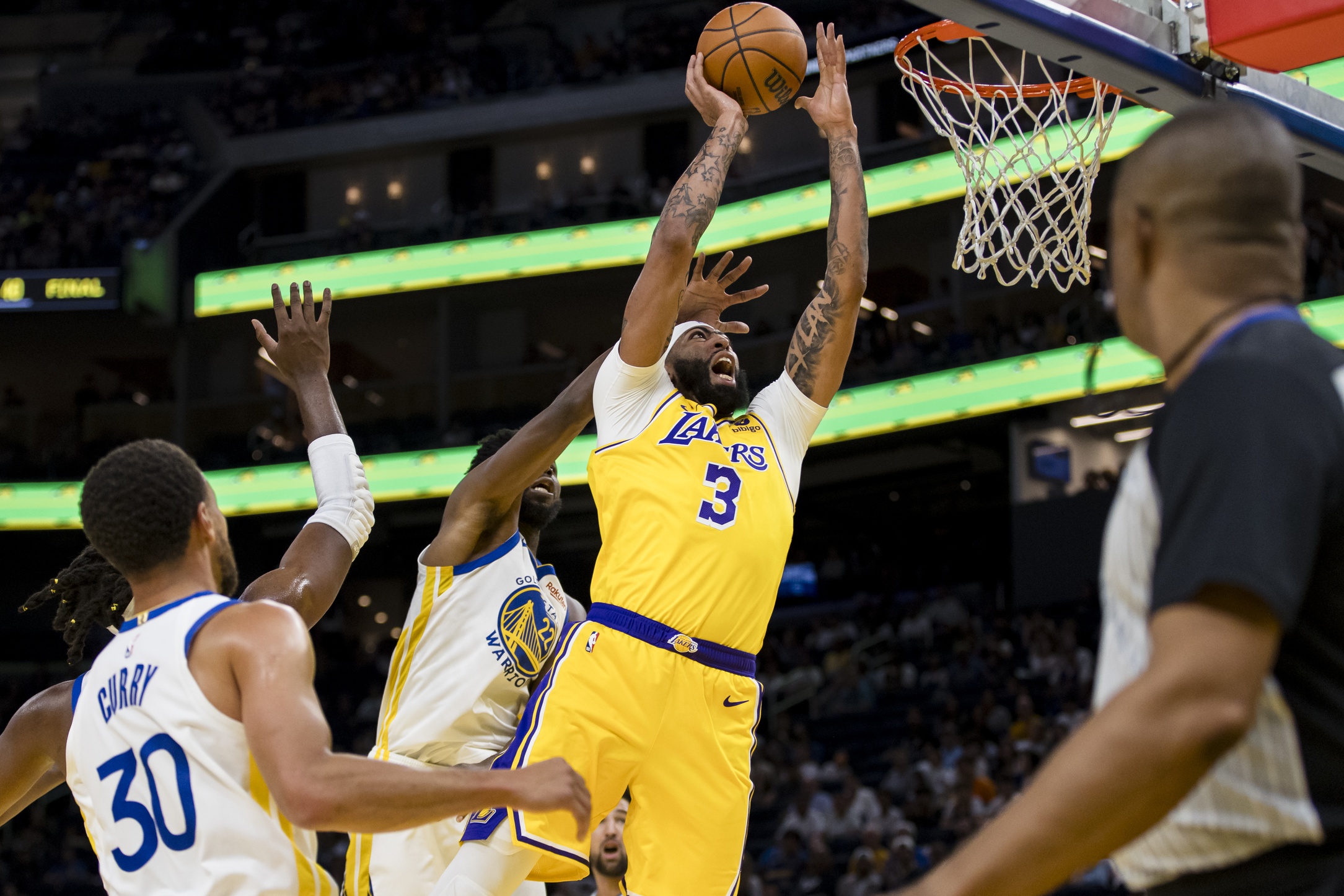 Oct 7, 2023; San Francisco, California, USA; Los Angeles Lakers center Anthony Davis (3) shoots in front of Golden State Warriors forward Andrew Wiggins (22) during the first half at Chase Center. Mandatory Credit: John Hefti-USA TODAY Sports