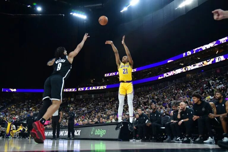 Oct 9, 2023; Las Vegas, Nevada, USA; Los Angeles Lakers forward Maxwell Lewis (21) shoots against Brooklyn Nets forward Trendon Watford (9) during the second half at T-Mobile Arena. Mandatory Credit: Gary A. Vasquez-USA TODAY Sports
