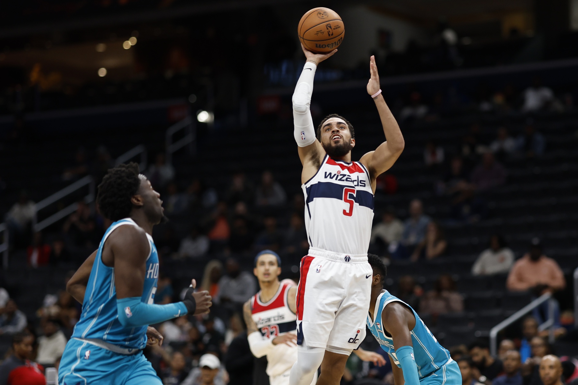 Oct 12, 2023; Washington, District of Columbia, USA;Washington Wizards guard Tyus Jones (5) shoots the ball over Charlotte Hornets center Mark Williams (5) in the third quarter at Capital One Arena. Mandatory Credit: Geoff Burke-USA TODAY Sports